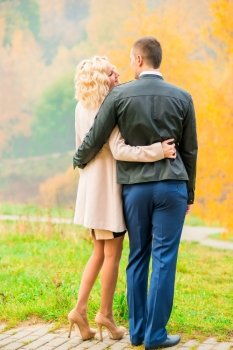 young couple embracing in autumn park