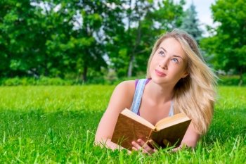 portrait of a pensive dreamy girl with novel