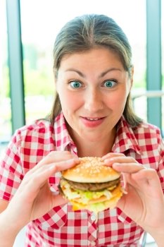 Portrait of hungry women and appetizing hamburger