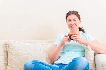 portrait of a charming girl sitting on the couch in the living room
