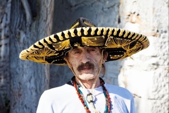 mexican man with sombrero posing outdoor