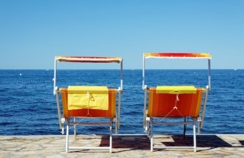 empty beach chairs on seaside
