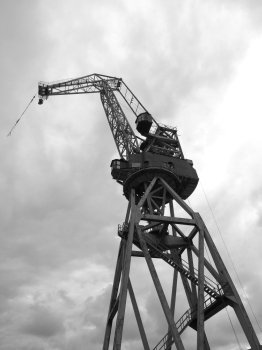 black and white  silhouettes of cranes in the shipyard.    