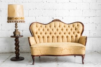 Brown Classical style Armchair sofa couch in vintage room with desk lamp