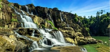 Tropical rainforest landscape panorama with flowing Pongour waterfall under blue sky. Da Lat, Vietnam