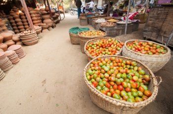 Ripe organic tomatoes for sale at outdoor asian marketplace. Bagan, Myanmar. Burma travel destinations