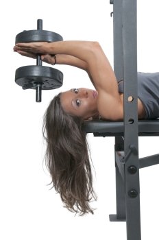 Beautiful young woman using weights during a workout. Industrial Excavator