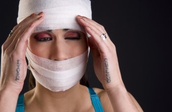 A woman in bandages feels acute pain