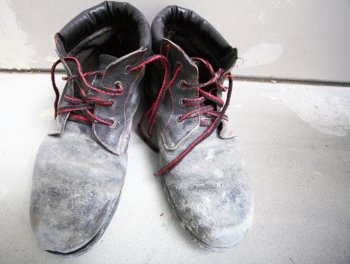 pair of old dirty work boots in construction site