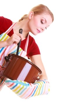 Happy housewife or chef in colorful kitchen apron with pot of soup and ladle isolated studio shot