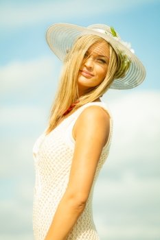 Fashion, happiness and lifestyle concept  Beautiful girl in hat on beach. Young woman relaxing on the sea coast.