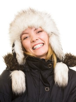 Winter vacation. Cheerful positive girl in warm clothes. Happy young woman in fur hat doing fun isolated on white.