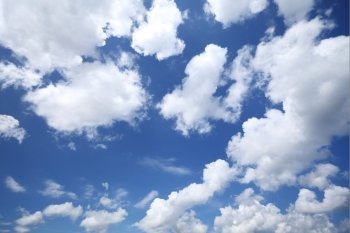 Deep blue sky background with white clouds