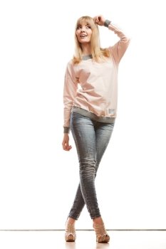 Fashion. Young blonde woman denim pants bright shirt high heels. Female model posing in full length isolated