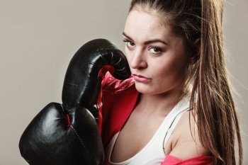 Training, boxing and exercises. Seductive women. Lifestyle concept. Fit girl with gloves on grey background in studio.