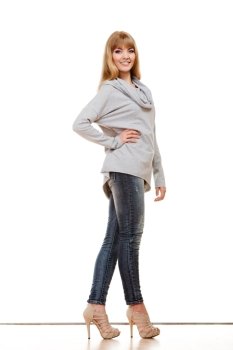 Fashion. Full body blonde fashionable woman jeans pants gray blouse. Female model standing isolated studio shot