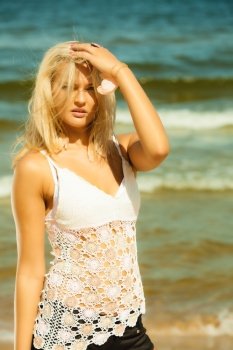 Holidays, vacation travel and freedom concept. closeup portrait of beauty romantic blonde girl outdoor on seashore. Her long hair blowing