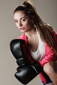 Training, boxing and exercises. Seductive women. Lifestyle concept. Fit girl with gloves on grey background in studio.