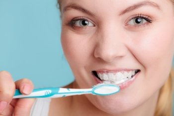 Young woman brushing cleaning teeth. Girl with toothbrush. Oral hygiene.
