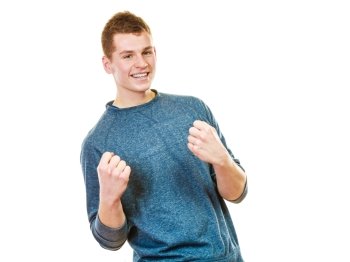Success positive emotions. Happy young man successful lad with arms up clenching fist isolated on white background