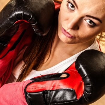 Emancipation and feminist. Defense concept. Young fit woman boxing. Indoor.