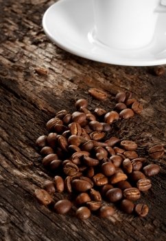 Grains and a cup of black coffee on a wooden background