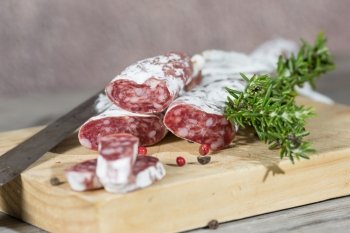 Salami sausage with homemade pepper on a cutting board