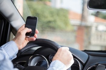Man with mobile distracted and driving your car