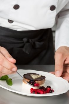 Chef decorating a homemade mousse with berries
