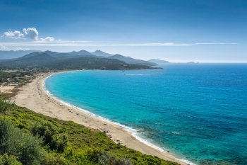 Losari beach with L’Ile Rousse in distance in the Balagne region of Corsica